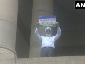 MP hoisted  poster on the roof of parliament building